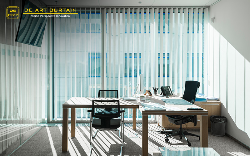 Office with large windows and white vertical blinds.