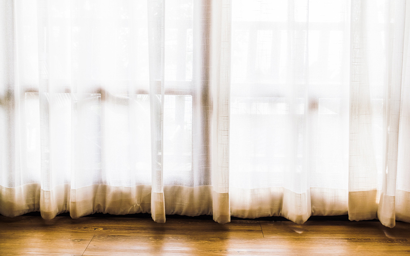 Sun-faded sheer curtains needing a replacement upgrade.